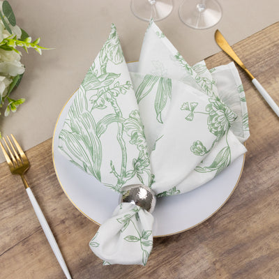 Floral patterned napkin elegantly arranged on a dining plate with cutlery.