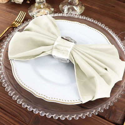 Elegant sage green bow napkin on a decorative plate.