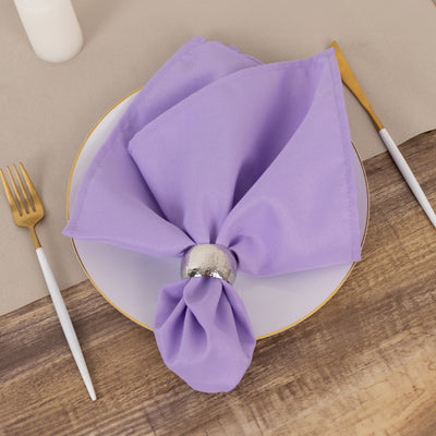 Lavender napkin elegantly arranged on a plate with a silver napkin ring.