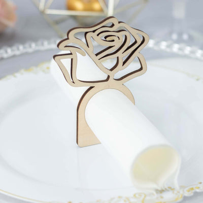 Rose-shaped wooden napkin holder on an elegant plate.