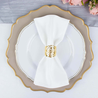 Elegant white napkin with gold ring on a decorative plate.
