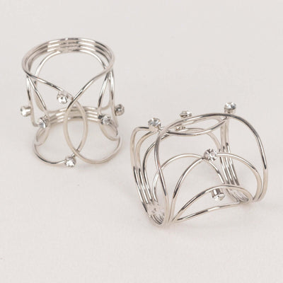 Silver wire rings with decorative crystals on a neutral background.