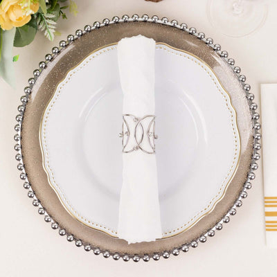 Elegant dinner plate with decorative rim and silver napkin holder