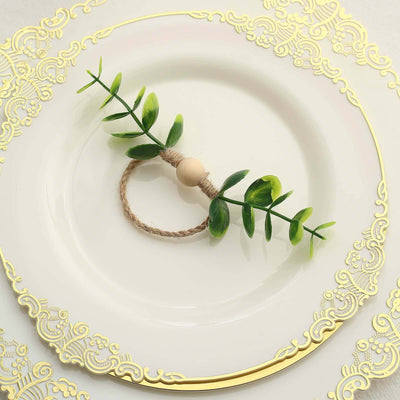 Green leaf napkin ring on a decorative plate.