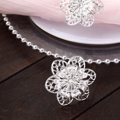 Silver floral table decoration on a wooden surface.