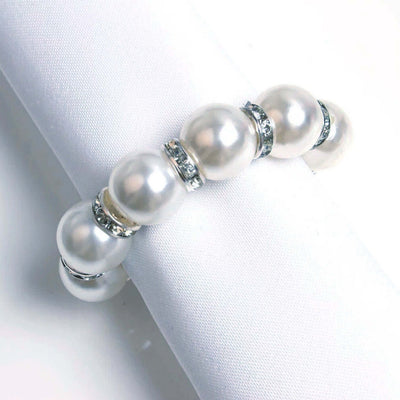 Elegant pearl bracelet with silver accents on a white background.