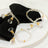 Elegant crystal napkin rings with gold accents on a marble table.