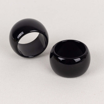 Black ceramic rings on a neutral background.