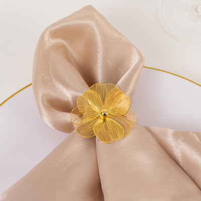 Elegant beige napkin adorned with a yellow flower accent.
