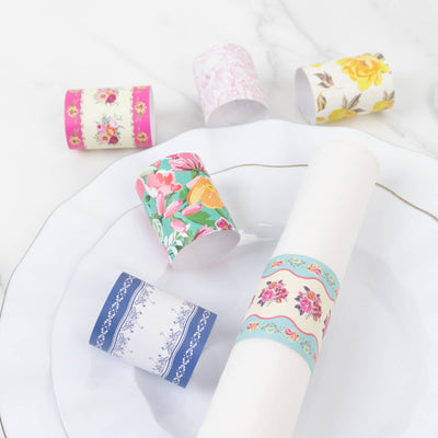 Colorful floral napkin rings displayed on a plate.