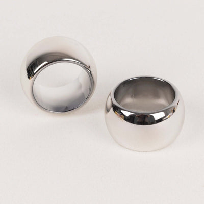 Shiny silver rings on a plain background