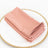 Set of four folded blush pink napkins on a decorative plate