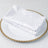 Elegant white napkins with sparkling details on a decorative plate.