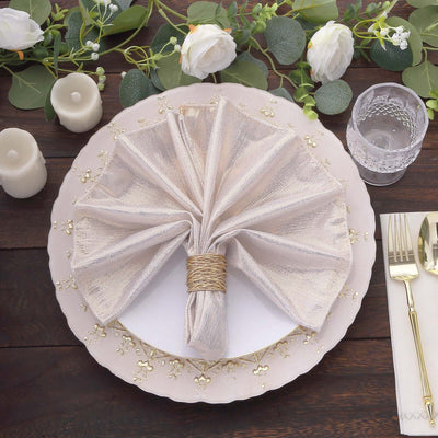 Elegant gold and cream napkin on a decorative plate with floral accents.