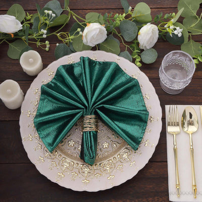 Elegant green napkin folded in an umbrella shape on a decorative plate