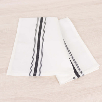 White kitchen towels with black stripes, neatly folded.