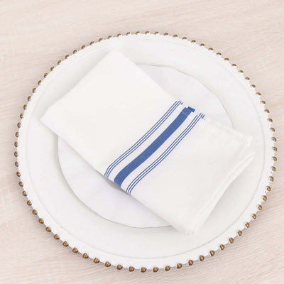 White napkin with blue stripes on decorative plate