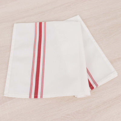 White napkin with red stripes folded neatly on a wooden surface.