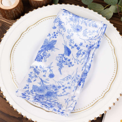 Blue floral patterned napkin on a decorative plate.