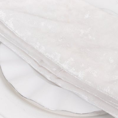 White velvet fabric folded on a plate.