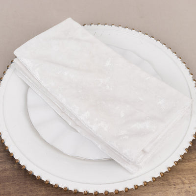 White textured napkin on a decorative plate.