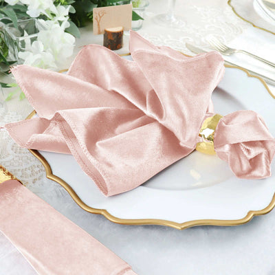 Blush pink velvet napkin elegantly styled on a white plate.
