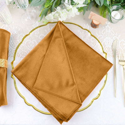 Elegant brown napkin neatly folded on a decorative gold plate.