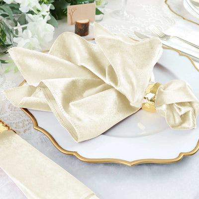 Elegant cream napkin folded on a decorative plate for a stylish table setting.
