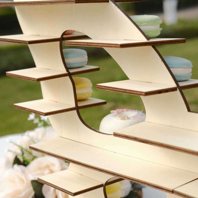 Elegant wooden display stand for macarons in a garden setting.