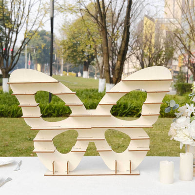 Wooden butterfly decor piece displayed in an outdoor setting.