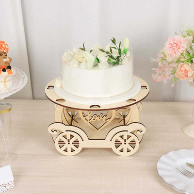Wedding cake stand with floral decoration on a wooden cart.