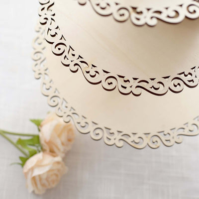 Decorative layered wooden cake stand with intricate cutout design.