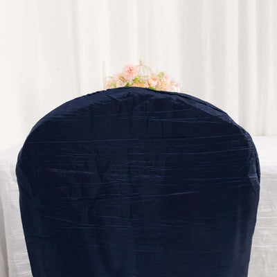 Navy blue chair cover on a white table with floral centerpiece.