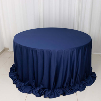 Navy blue round tablecloth with ruffled edges on a plain background