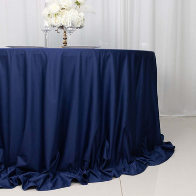 Navy tablecloth draped elegantly over a round table with floral centerpiece.