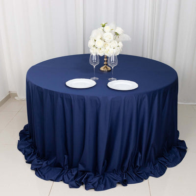 Navy tablecloth draped elegantly on a round table with floral centerpiece and dinnerware.