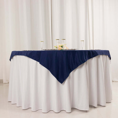 Navy tablecloth draped elegantly over a white table in a bright setting.
