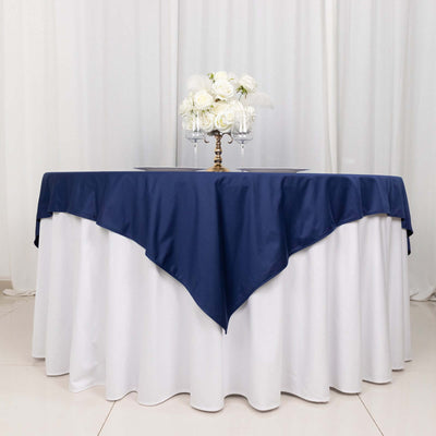 Navy tablecloth draped elegantly over a round table with floral centerpiece.