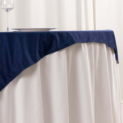 Navy tablecloth draped over a white table for elegant dining settings.