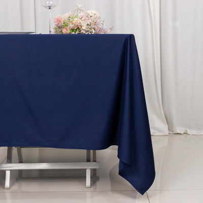 Navy blue tablecloth draped elegantly on a table with floral arrangement