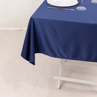 Navy blue tablecloth draped over a table with elegant dining setup