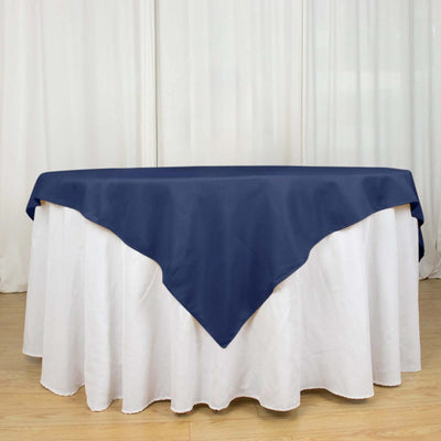 Navy tablecloth draped over a white table for elegant dining