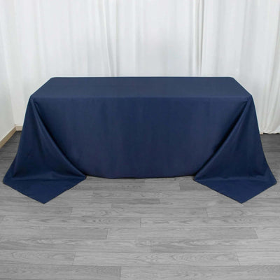 Navy blue tablecloth draped over a table against a plain background