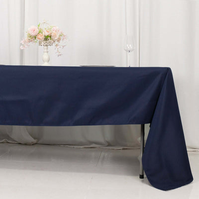 Navy blue tablecloth draped elegantly on a table with floral centerpiece