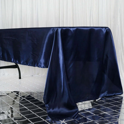 Navy satin tablecloth draping elegantly over a table