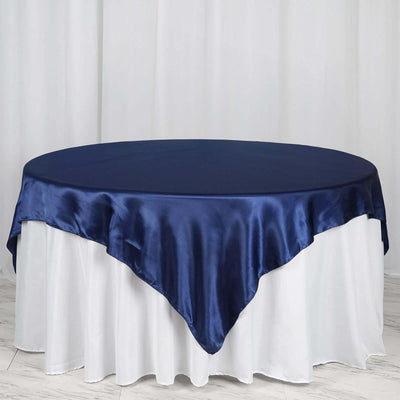 Navy satin table cover draped elegantly over a white table.