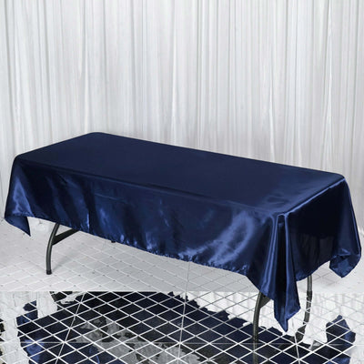 Navy satin tablecloth draped over a table in a studio setting.