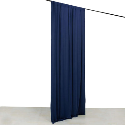 Navy blue curtain draped on a rod against a plain background