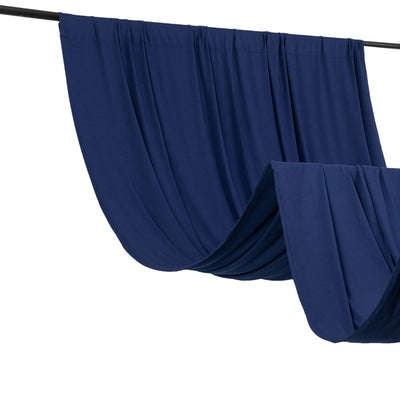 Navy drapery fabric hanging on a black rod in studio-style isolation shot