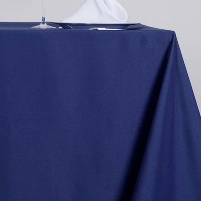 Navy blue tablecloth draped elegantly over a table setting.